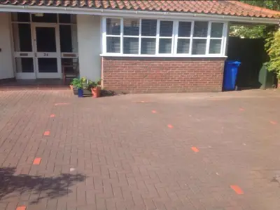 a brick parking lot in front of a brick house at The Clan MacGregor Room in Kilmarnock