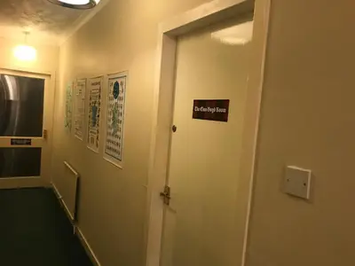 a hallway with a door with a sign on it at The Clan MacGregor Room in Kilmarnock