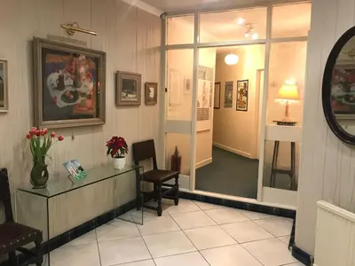 a lobby with a desk and chairs and a window at The Clan MacGregor Room in Kilmarnock