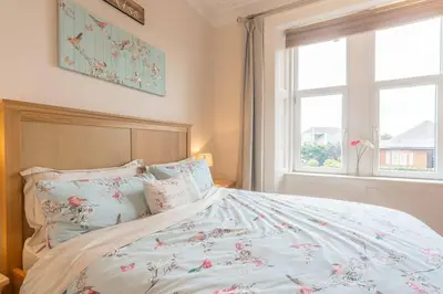 a bedroom with a bed and a window at Arran View in Prestwick