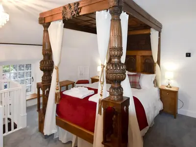 a bedroom with a four poster canopy bed at Field House Cottage - Uk12573 in Borrowdale Valley
