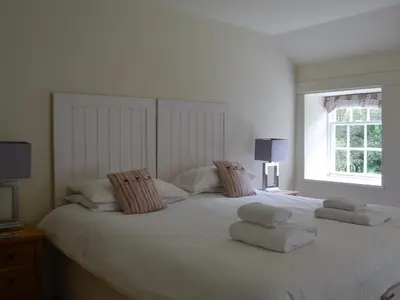 a bedroom with a large white bed with two pillows at Orchard Cottage - Uk12525 in Garlieston