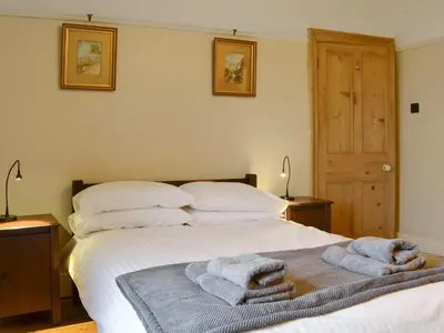 a bedroom with a bed with towels on it at Kingswood in Whitehaven