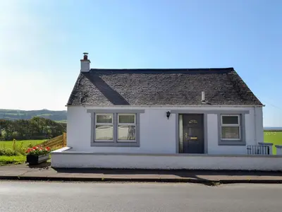 a white house with a black roof at Stinchar View in Ballantrae