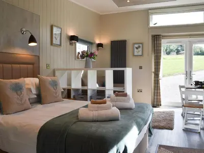 a bedroom with a large bed with two pillows on it at Lapwing in Westward