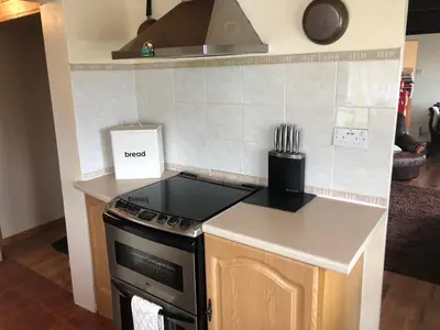 a kitchen with a stove and a counter top at Mona Villa Holiday Home in Coulderton