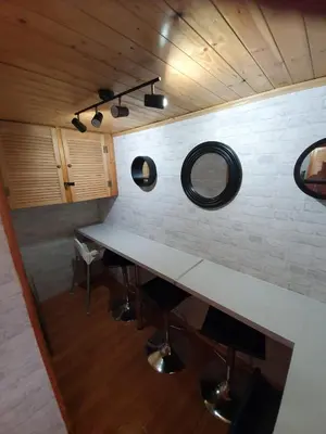 a room with a table and two mirrors on the wall at Mona Villa Holiday Home in Coulderton