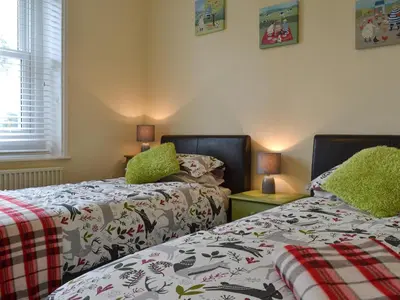 two beds sitting next to each other in a bedroom at Blaithwaite Cottage in Blencogo