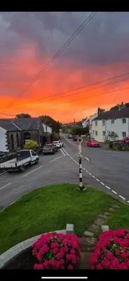 a view of a street with a sunset at Rose Cottage in Wigton