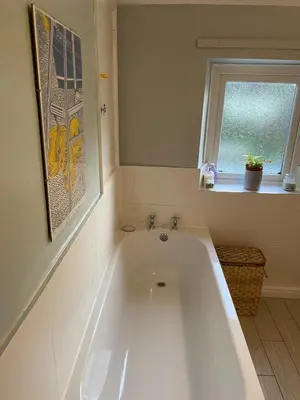 a white bath tub in a bathroom with a window at Rose Cottage in Wigton