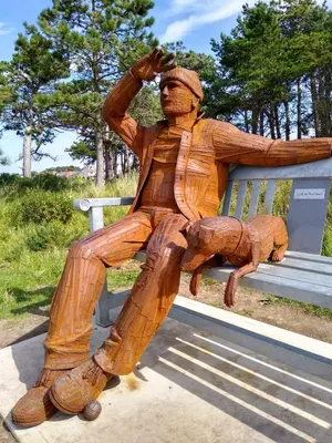 a statue of a man sitting on a bench at Green View Guest House in Silloth