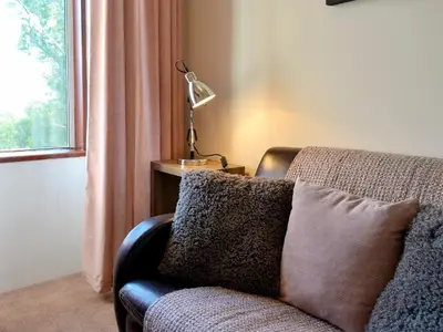 a living room with a couch and a window at Butterhole Farmhouse in Kelton