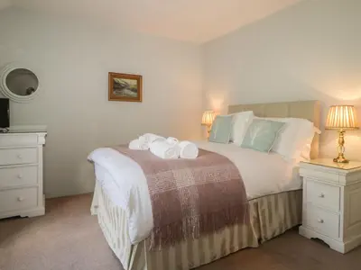 a bedroom with a bed with towels on it at Stair Cottage in Keswick