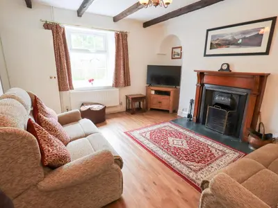 a living room with two couches and a fireplace at Millcroft in Penrith