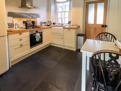 a kitchen with white cabinets and a stove top oven at Beck Steps 1 in Grasmere