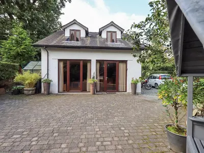 a house with a brick driveway in front of it at Stonegarth Mews in Ambleside