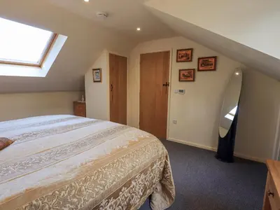 a bedroom with a large bed and a window at Stonegarth Mews in Ambleside