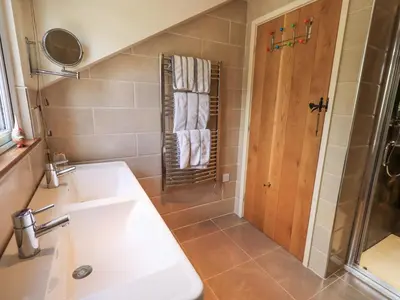 a bathroom with a sink and a shower at Stonegarth Mews in Ambleside
