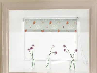 a window with three vases with flowers in it at High Street in Kirkcudbright