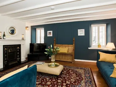 a living room with blue walls and a blue couch at High Street in Kirkcudbright