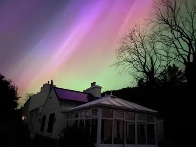 a house with a rainbow in the sky at Carrick Beg Self Catering Holiday Accommodation with Hot Tub in Sulby