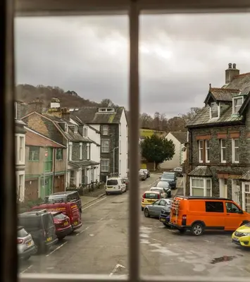 a view from a window of a city street with cars at Portland House in Keswick