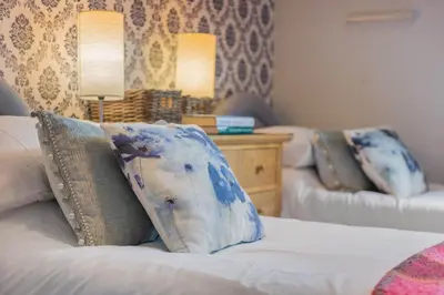 a room with a bed with two pillows on it at Big White House in Cockermouth