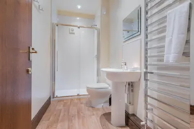 a bathroom with a toilet and a sink and a shower at Big White House in Cockermouth
