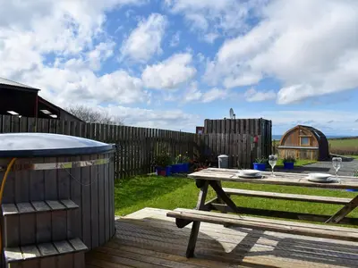 a picnic table in a backyard with a fence at Black Coombe-Uk1392 in Corney