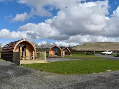 a couple of small huts in a parking lot at Black Coombe-Uk1392 in Corney