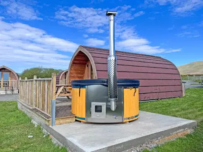 a large building with a woodburning stove next to a house at Selker View-Uk1397 in Corney