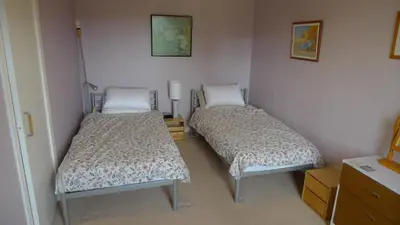 two beds in a small room withermottermottermott at Bonshawbrae in Kirtlebridge