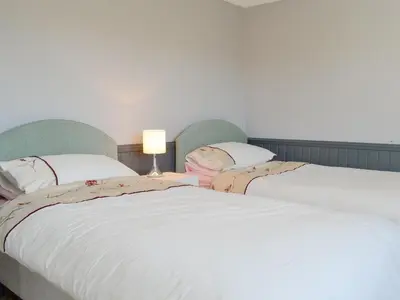 two beds sitting next to each other in a bedroom at Wavecrest in Mainsriddle