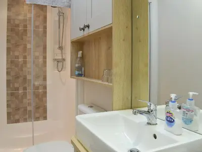 a bathroom with a sink and a shower and a mirror at Watches - Uk13544 in Bassenthwaite