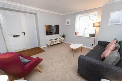 a living room with two couches and a tv at Fellseeker in Keswick