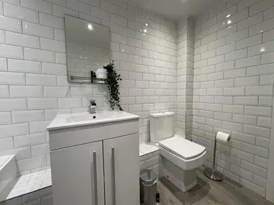 a bathroom with a toilet and a sink and a mirror at Fellseeker in Keswick