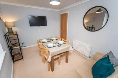 a dining room with a table and a mirror at Fellseeker in Keswick