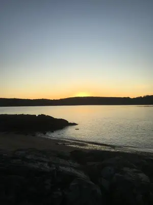 a sunset over the water with a beach at STUNNING LODGE - HOME FROM HOME Kippford, Dalbeattie in Dalbeattie