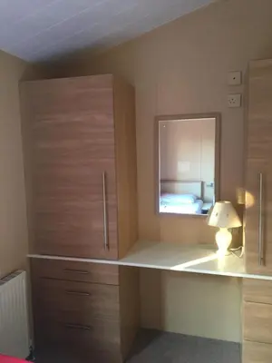 a bedroom with a desk with a mirror and a bed at STUNNING LODGE - HOME FROM HOME Kippford, Dalbeattie in Dalbeattie