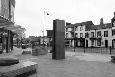 a black and white photo of a square with buildings at The Sleepwell Inn in Workington