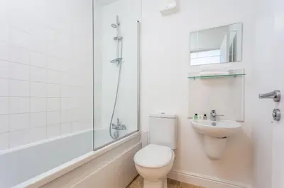 a bathroom with a toilet and a shower and a sink at Elliot Suite No 1 - Donnini Apartments in Ayr