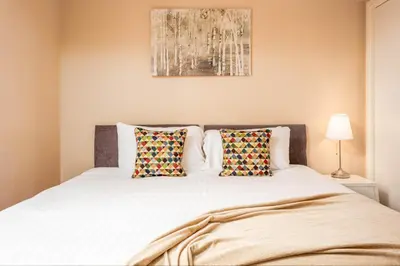 a bedroom with a white bed with two pillows at Elliot Suite No3 - Donnini Apartments in Ayr