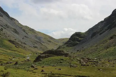 a valley with a river in the middle of a mountain at DAIRY MAIDS COTTAGE in Seascale