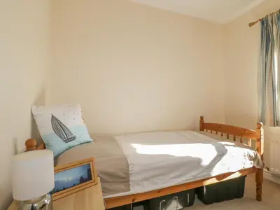 a bedroom with a bed and a television in it at Rowan Cottage in St Bees