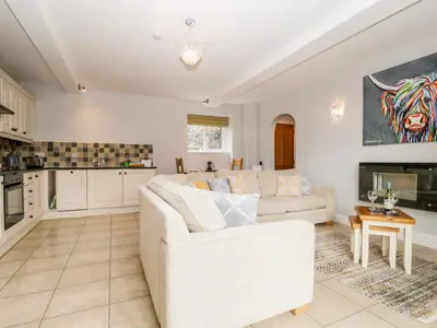 a living room with a white couch and a kitchen at High Spy in Keswick