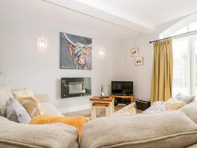 a living room with a couch and a tv at High Spy in Keswick