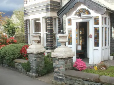 a house with a white door and flowers in front of it at Dalkeith Guest House in Keswick