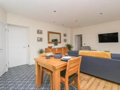 a living room with a table and a couch at Hillcrest in Newton Stewart