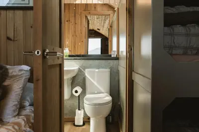 a bathroom with a toilet and a sink at The Huts at Highside Farm in Keswick