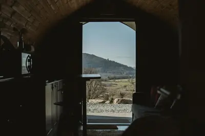 a window in a room with a view of a mountain at The Huts at Highside Farm in Keswick